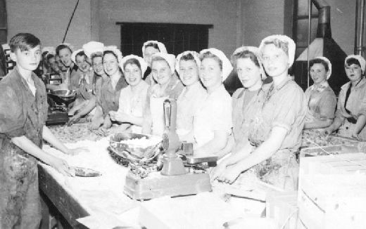 Image from object titled 'Factory workers in weighing room at Ewbanks Ltd liquorice works.'